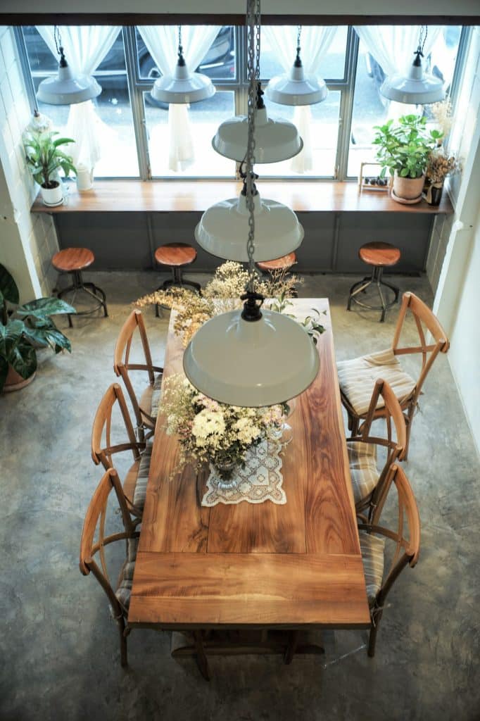 Top view perspective interior design of coffee shop with the wooden furnitures and vintage lamp.